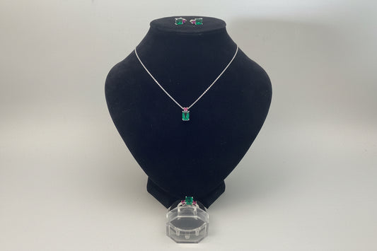 Black embroidered hat on a white surface with a clear box in the background