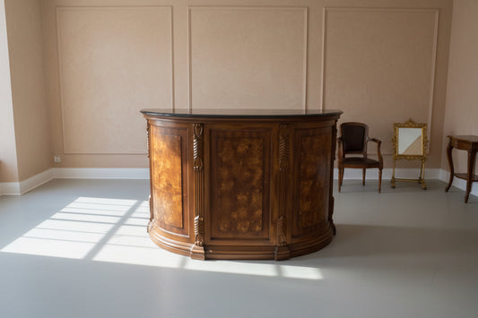 Wooden bar cabinet with black countertop in a room setting