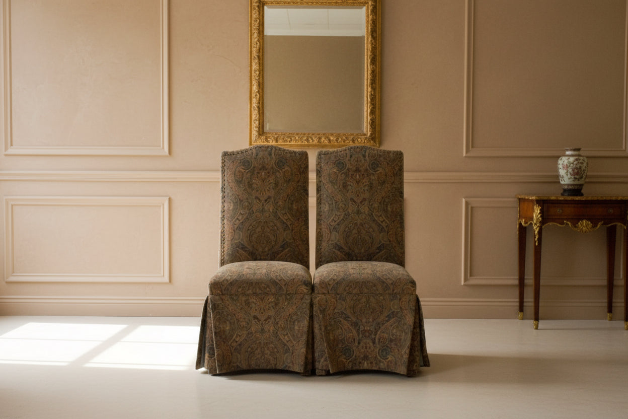 Two patterned chairs in a cluttered room with various items.
